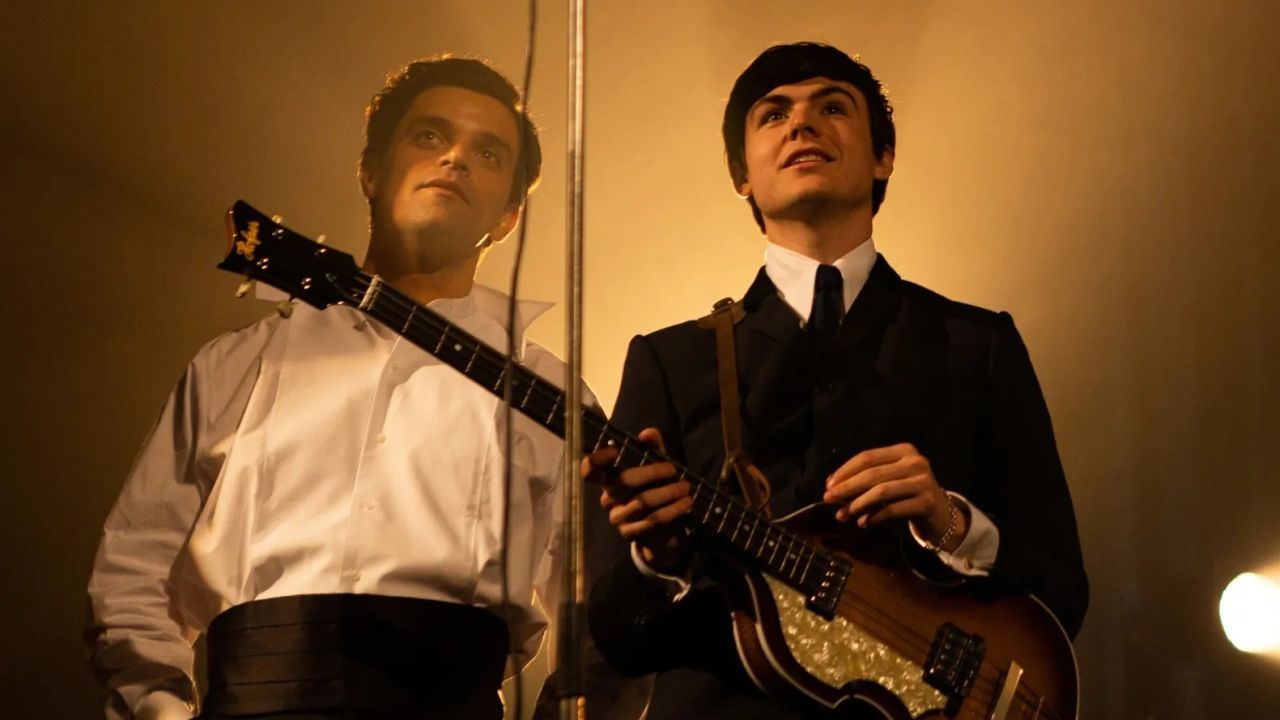 Brian Epstein is also spatially the man behind Paul McCartney (Blake Richardson).