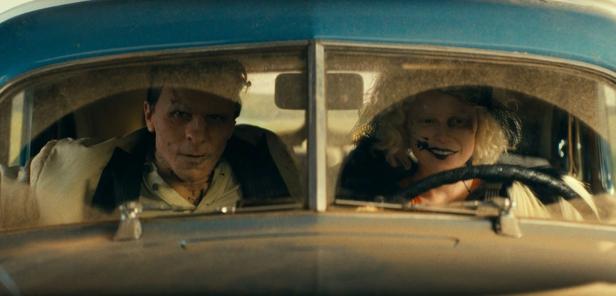 Jessie Buckley and Christian Bale drive an old car as the bride and Frankenstein's monster
