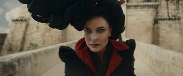 Rebecca Ferguson with an eccentric outfit on a bridge in front of a castle