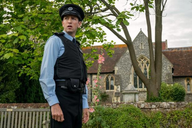 Policeman stands in front of the church on English Orfplatz
