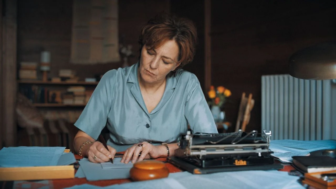 Although the writer has enough money, she refuses to buy her house because, as a staunch GDR socialist, she rejects private ownership of land.