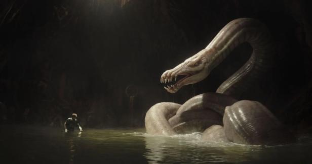 In a dark cave, a man stands in the water in front of a huge, white snake.
