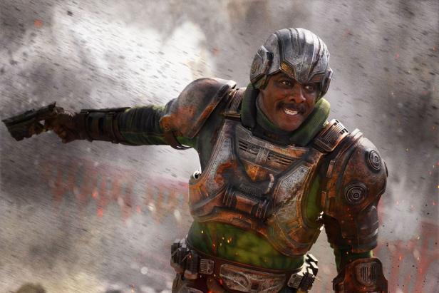 Man in futuristic armored armor with helmet aims a weapon surrounded by smoke and sparks.