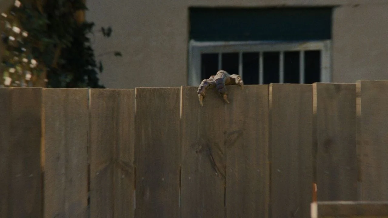 In one of the best-staged scenes in the film, you can hardly see the dinosaur behind the garden fence - but you can still see what he's doing there!