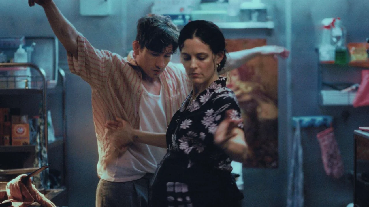 Zalya (Riley Keough) needs all the help she can get in her Circassian diner, but Azik (Barry Keoghan) keeps getting distracted by his crazy ideas.