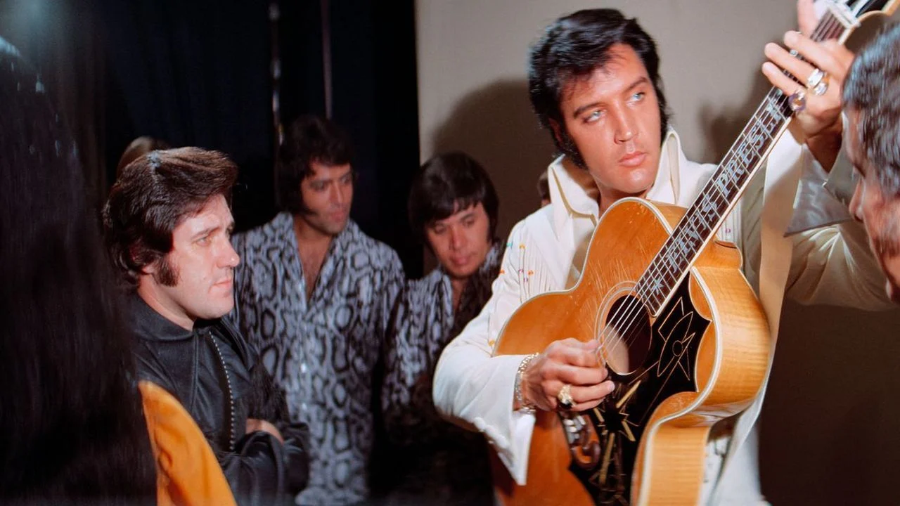 Even his own band is mesmerized by Elvis.