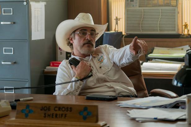 Joaquin Phoenix as the sheriff is currently on the landline in his office
