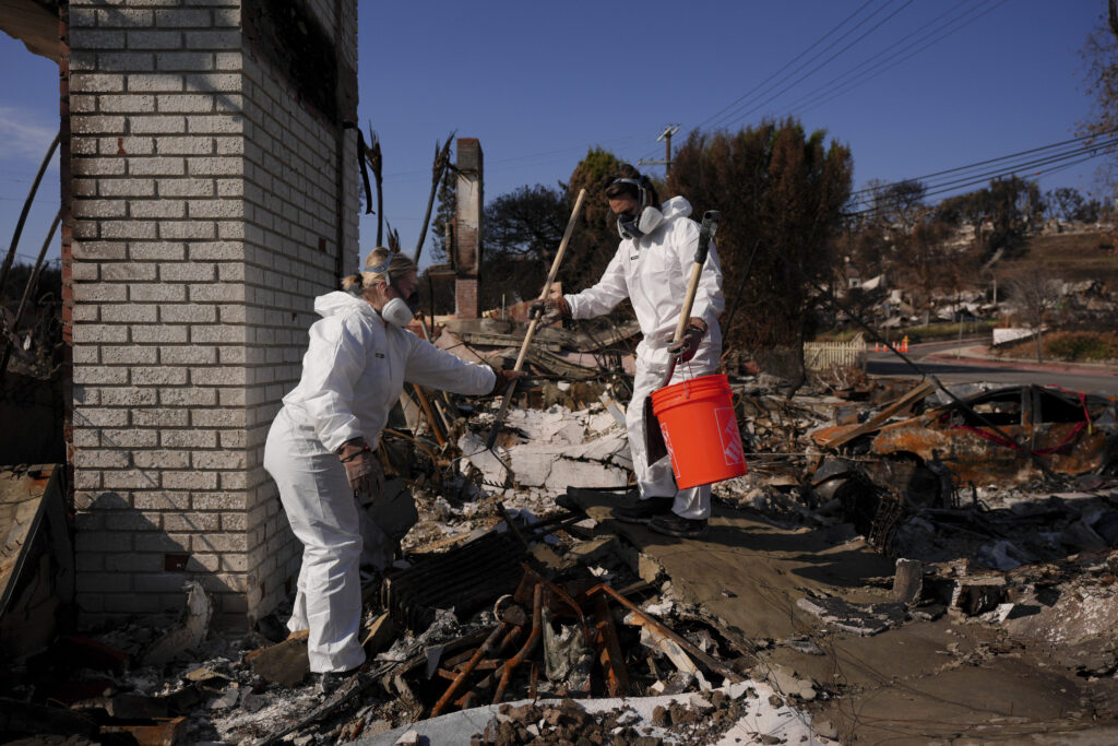 Evacuated residents wait hours to return to burned neighborhoods of the