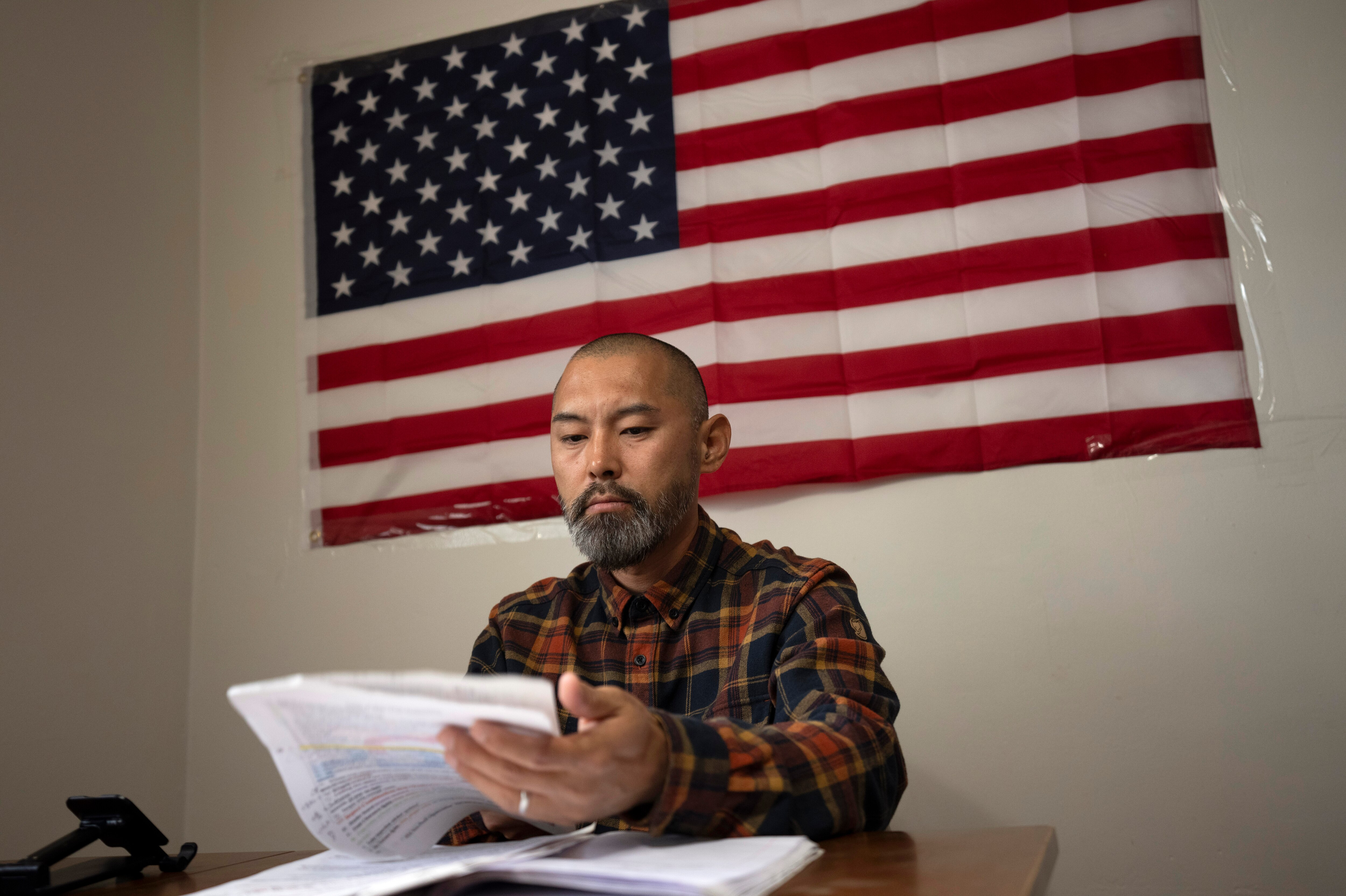 FILE - Chinese migrant Li Kai, also known as Khaled, an ethnic Hui Muslim, studies for a commercial driver's license at his apartment in Flushing, New York, on May 3, 2024.