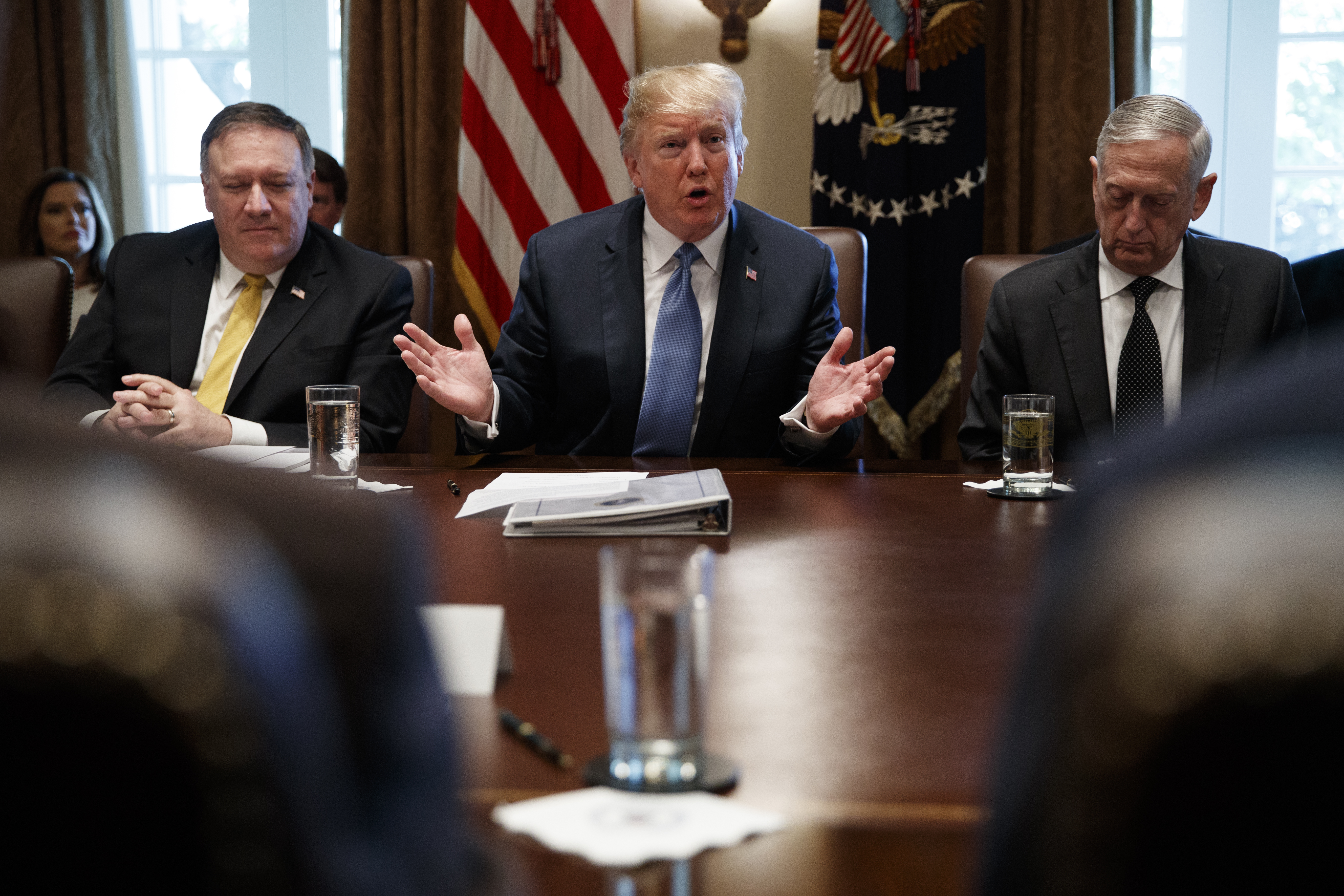 FILE - Secretary of State Mike Pompeo, left, and Secretary of Defense Jim Mattis, right, listen as President Donald Trump speaks during a Cabinet meeting at the White House, June 21, 2018.