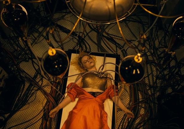 Jessie Buckley lies on an operating table as the future bride of Frankenstein