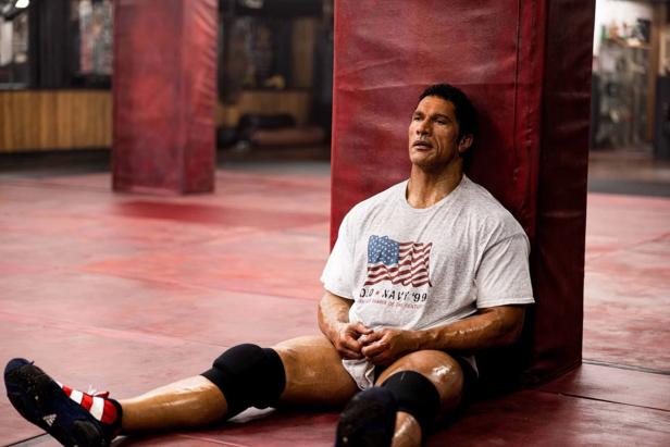 Dwayne Johnson sits on the floor as wrestler Mike Kerr