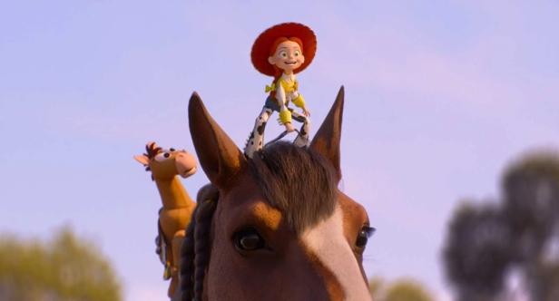 Jessie from Toy Story rides on the head of a horse while Bullseye is seen in the background.