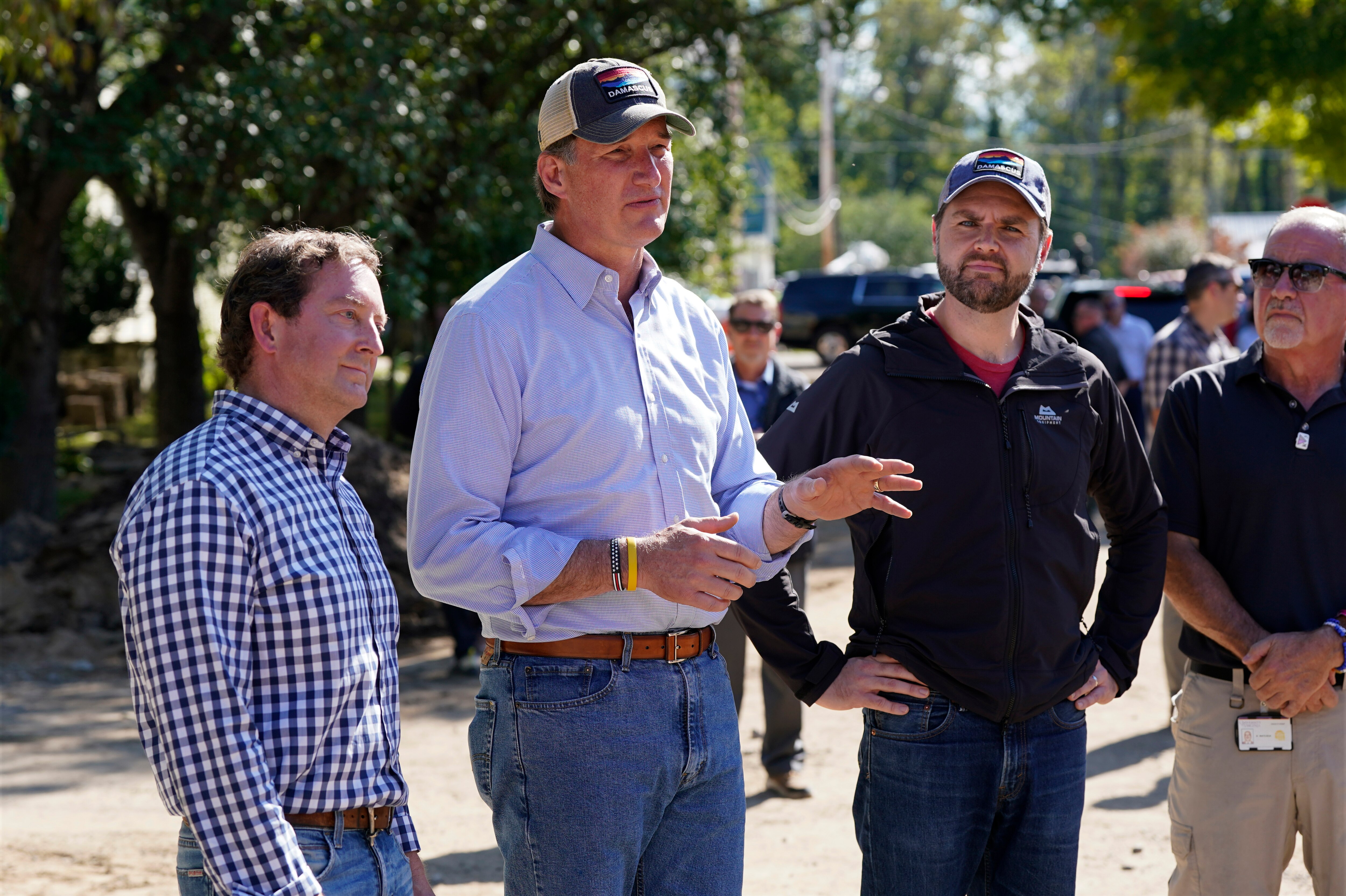 FILE - Republican vice presidential candidate JD Vance listens to Virginia Gov. Glenn Youngkin as he visits areas affected by Hurricane Helene in Damascus, Virginia, Thursday, Oct. 3, 2024. At left, state senator Todd Pillion.