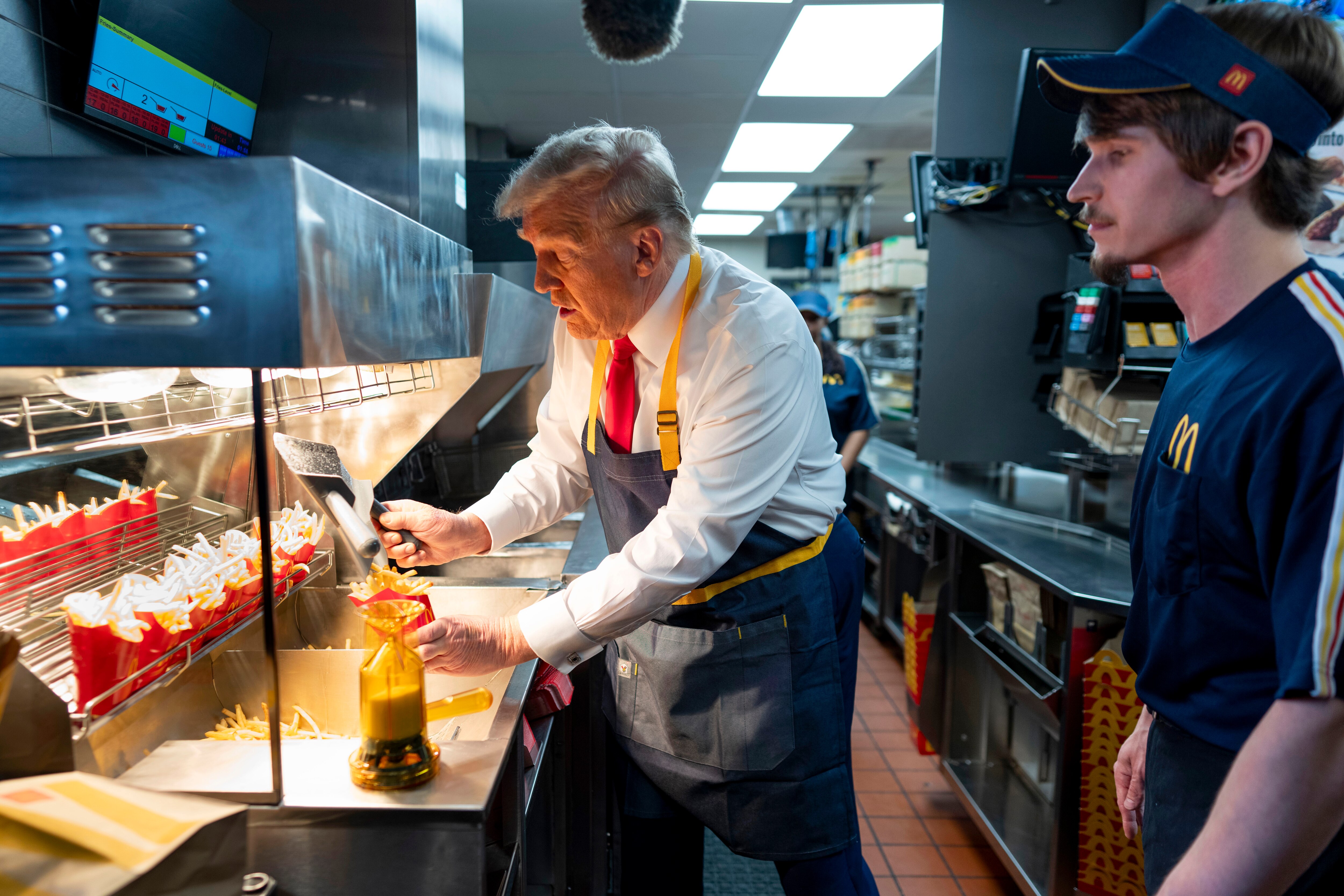 Former President and Republican candidate Donald Trump uses a deep fryer at a McDonald's restaurant in Feasterville-Trevose, Pennsylvania, on October 20, 2024. (FILE: AP)